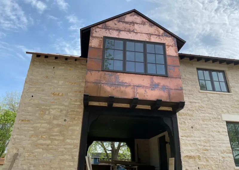 Copper metal panel facade on a stone building for Skylight Installation in Batesburg-Leesville